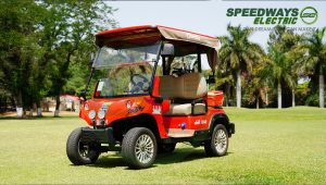 a red golf cart on a grassy field
